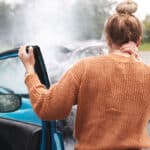 Woman holding the back of her neck after a car wreck